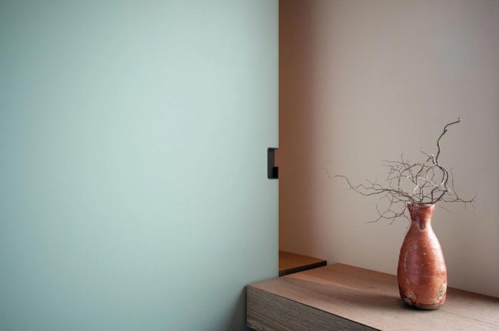 Close detail of a frosted sliding door panel and hardware in a finished interior